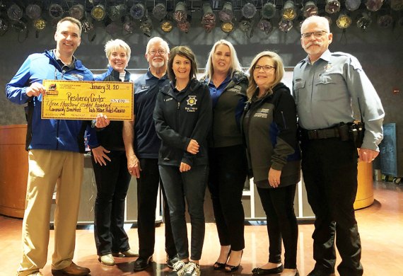 Fresno Police Chaplaincy Resiliency Center members accept monthly breakfast donation check from Palace Hotel and Casino.